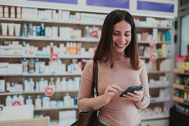 istock Woman smiling using smartphone shopping in pharmacy 2252284832
