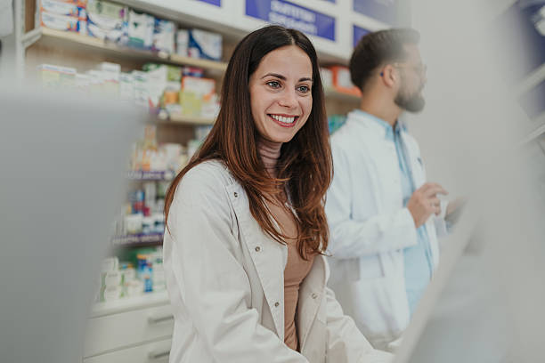 istock Female pharmacist smiling working in modern drugstore 2252284914