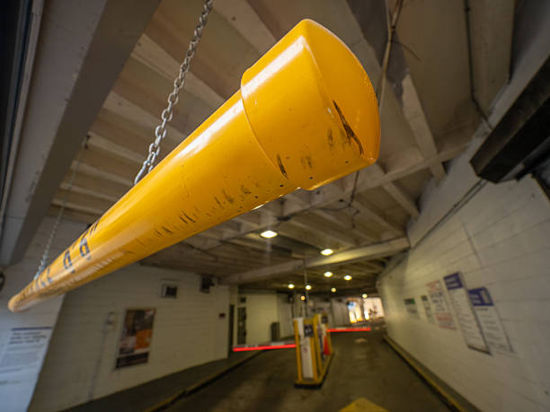 istock Yellow barrier arm controls access in parking garage 2252286327