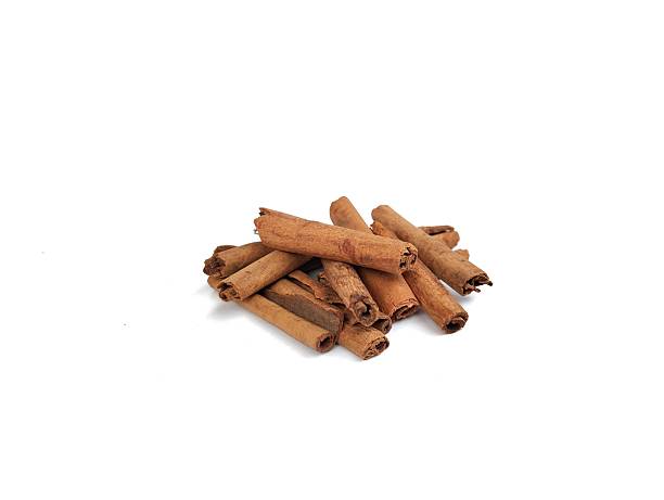 istock Pile of dry cinnamon sticks isolated on white background 2252287844
