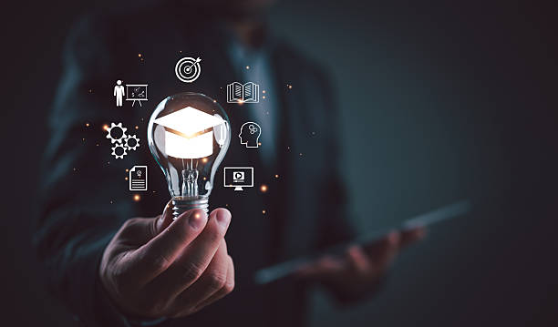 istock Innovative education and e-learning concept photograph, lightbulb with graduation cap inside representing knowledge and academic achievement. 2252288528