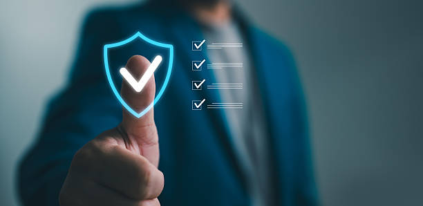 istock Professional businessman giving thumbs up with digital security shield and checklist, representing corporate safety and compliance photograph. 2252288530