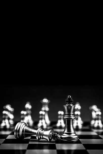 King chess pieces stand on falling chess in vertical concepts of challenge of leader business team or teamwork volunteer or wining and leadership strategic plan and risk management or team player.