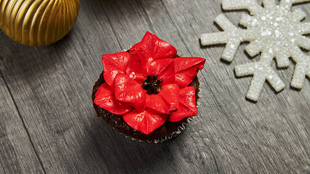 Christmas cupcake with decorative red poinsettia flower