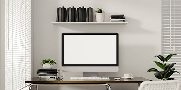 An organized home office featuring a computer, bookshelves, and green plants for a refreshing workspace.