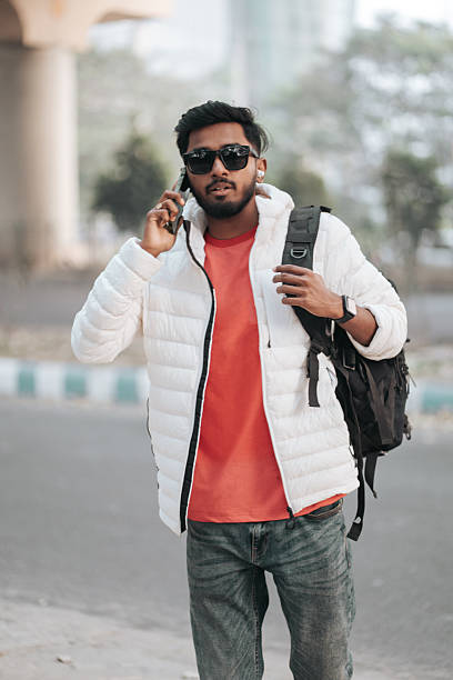 istock Young Man Talking on Smartphone While Walking in Urban Area 2252295155