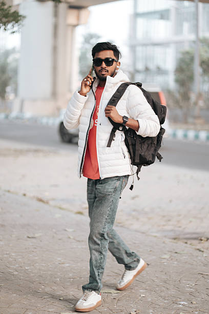 istock Smiling Young Man Talking on Smartphone in Urban Environment 2252296493