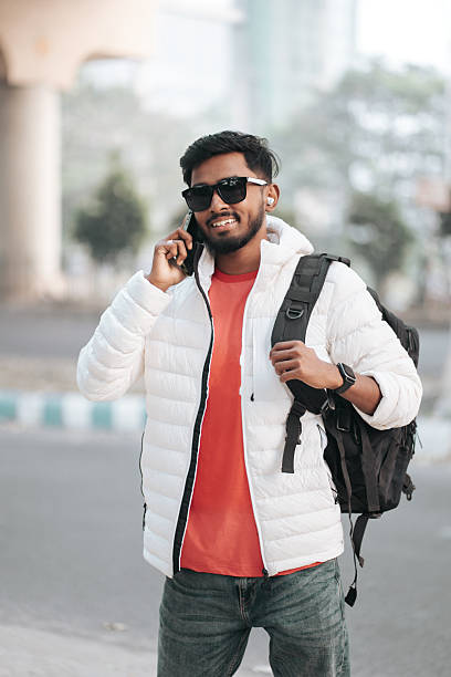 istock Smiling Young Man Talking on Smartphone in Urban Environment 2252296533