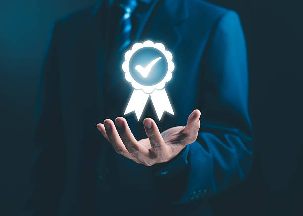 Businessman holding golden premium quality badge, excellence standard, top performance, trust assurance, customer satisfaction, high quality product concept