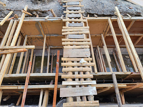 istock Temporary wooden ladder bridge over drainage construction site, planks and timber formwork for concrete channel, urban infrastructure development and road construction work 2252299941