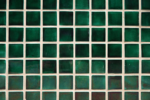 Small green tiles with white grout set in a grid