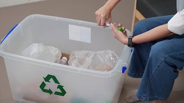 istock Recycling initiative. Woman sorting plastic bottles for recycling. 2252300017