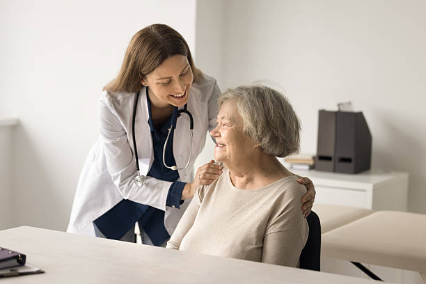 istock Happy medical worker touch older lady shoulder express support 2252303171