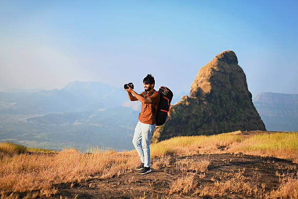 istock Solo Traveler Taking Photos with Camera on Mountain Ridge 2252304155