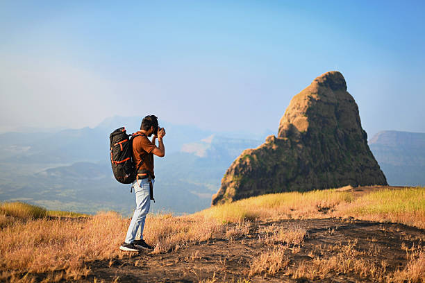 istock Young Man Backpacker Photographing Mountain Landscape During Solo Trek 2252304158