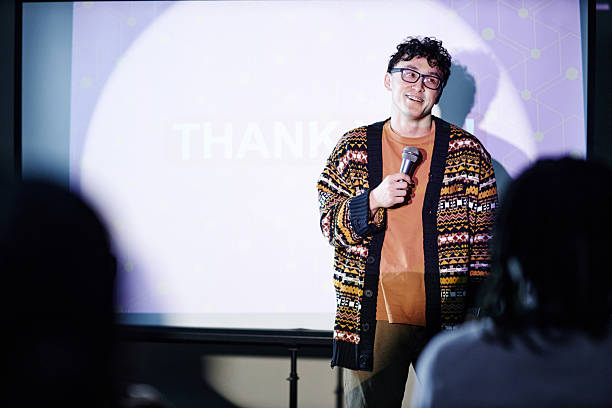 istock Young Adult Man Smiling While Giving Presentation with Microphone 2252306061