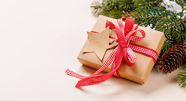 istock Gift box on snowy fir branches on beige background 2252307496