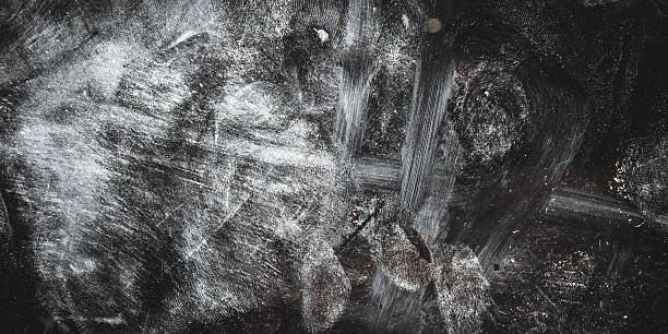 istock Abstract black grunge textured background with white scratches, stains, and dust effects. The rough, worn surface creates a dramatic, dark, and artistic impression. 2252307585