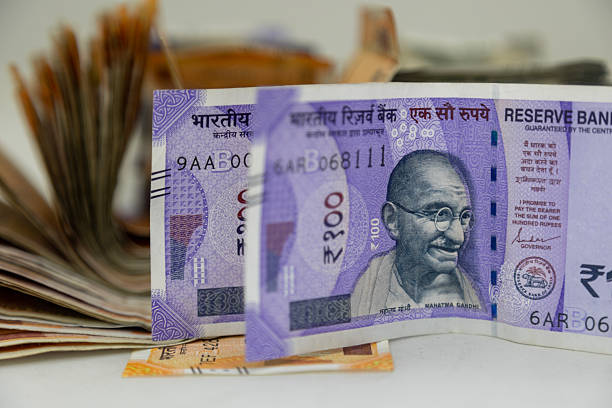 istock Indian Rupee 100 Currency Notes with Fanned Cash Background 2252308909