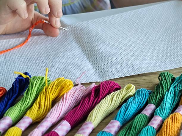 istock Person uses needle and thread to create craft project with colorful embroidery floss 2252309008