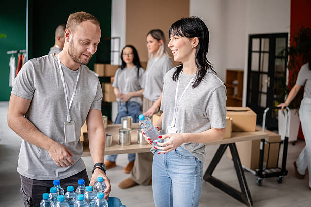istock Volunteers work together in a community service event, arranging donations and packaging supplies for those in need 2252310607