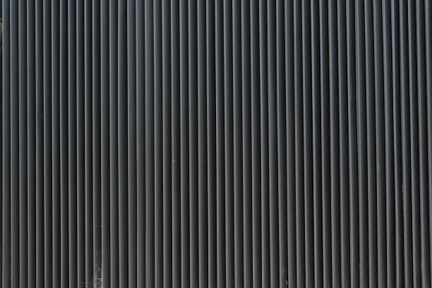 Dark gray metal slat wall.