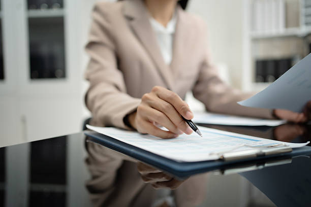 istock Young Asian businesswoman working at a modern office desk, analyzing documents with a laptop and calculator, demonstrating professionalism, focus, productivity, finance management, corporate 2252313368