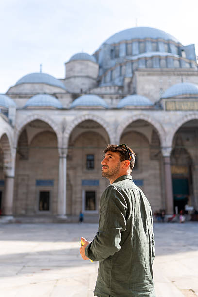 istock Man looking up visiting historic Istanbul mosque 2252316617
