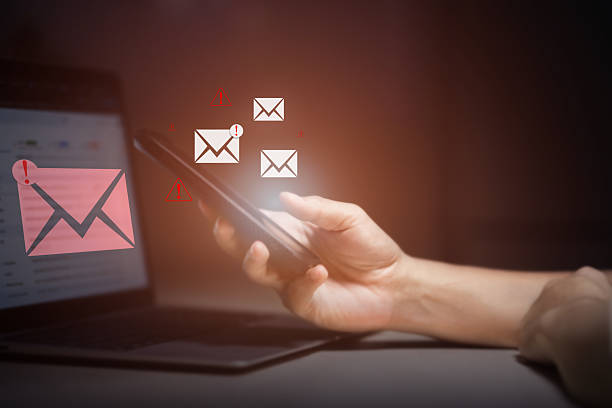istock person typing on laptop receives scam notification, illustrating cybersecurity risk and data breach threat, Spam mail pop-up warning. E-mail inbox with spam virus message, Trash and junk mail, scam. 2252317782