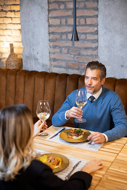istock Couple enjoys dinner with drinks at a restaurant in the evening 2252318895