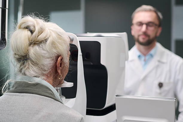 istock Senior Woman Undergoing Eye Examination with Ophthalmologist Present 2252319938