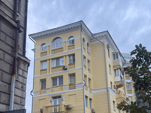 istock A yellow building stands tall with multiple balconies and windows in a city 2252322687