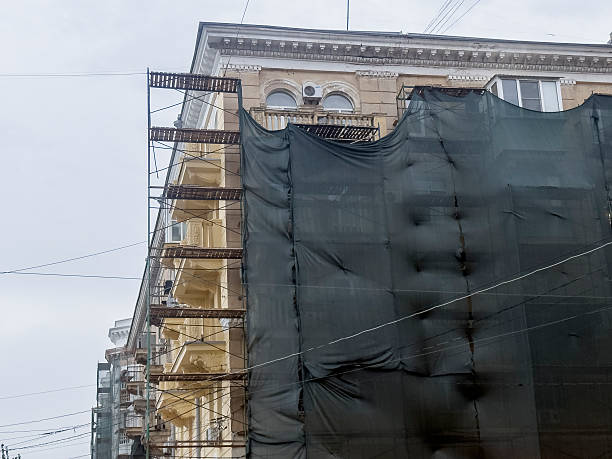 istock Workers are preparing a building for renovation with scaffolding and a covering 2252322695