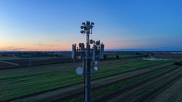 istock Telecommunication tower providing 5G mobile network connectivity, standing tall in a rural agricultural field at dawn, symbolizing modern technology and global communication infrastructure 2252332275