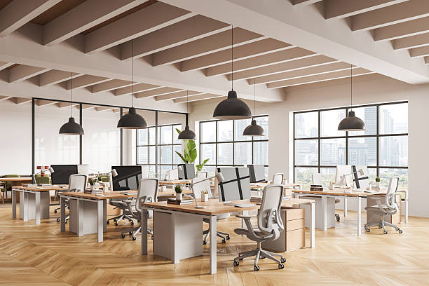 istock Modern open office interior with wooden flooring, ergonomic chairs, and large windows showcasing urban skyline views during daytime. 3D Rendering 2252333513