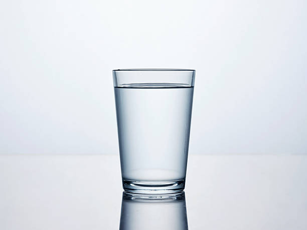 istock Glass of fresh water on reflective surface 2252335489