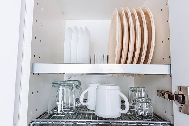 istock Organized Kitchen Cabinet with Neatly Stacked Dishes, Glassware, and Utensils Displaying a Minimalistic and Functional Design for Efficient Cooking and Dining 2252335933