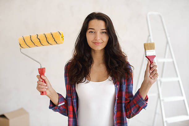 istock Smiling Woman Holding Paint Tools During Home Renovation Project Indoors 2252338679