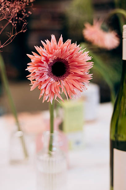 istock Bright pink gerbera in a vase on a decorated festive table. 2252338755