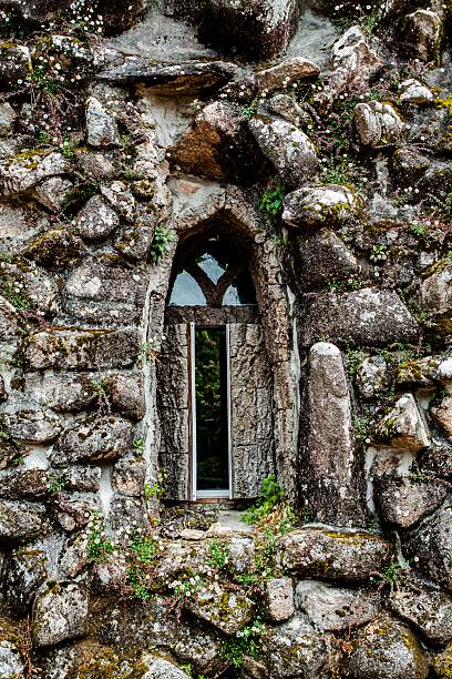 istock Intricate Stonework Window Framed by Nature's Embrace on an Ancient Ruined Structure 2252339220