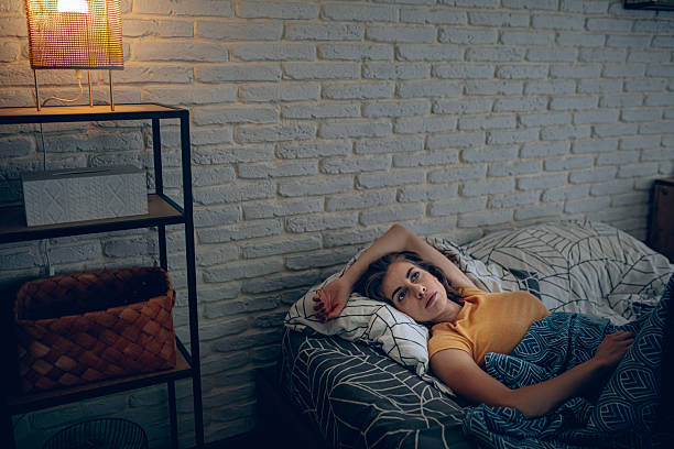 istock Exhausted woman resting in bed, unable to fall asleep 2252339269