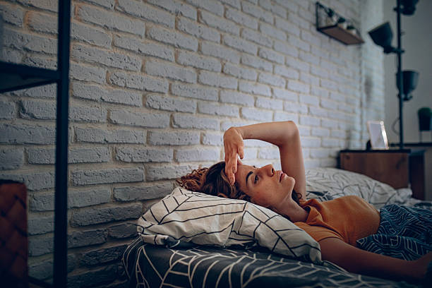 istock Exhausted woman resting in bed, unable to fall asleep 2252339398