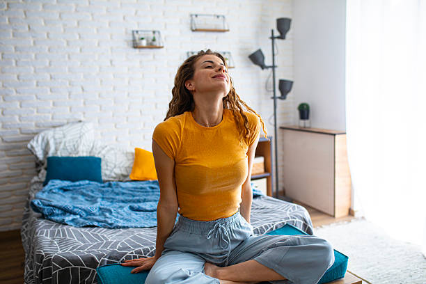 istock Rested woman sitting on bed in the morning light 2252340036