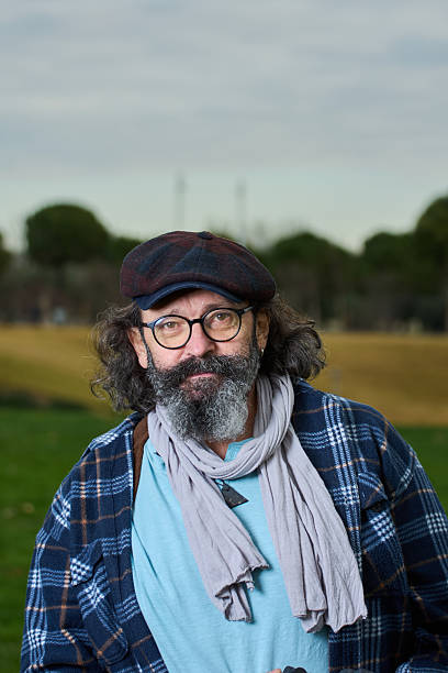 istock Middle age man smiling outdoors at the park 2252340114