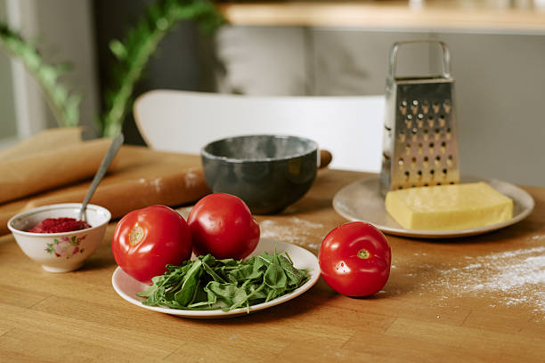 istock Fresh Tomatoes and Arugula with Cheese and Grater Preparing for Cooking 2252340241