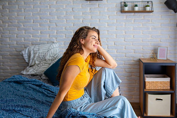 istock Rested woman sitting on bed in the morning light 2252340458