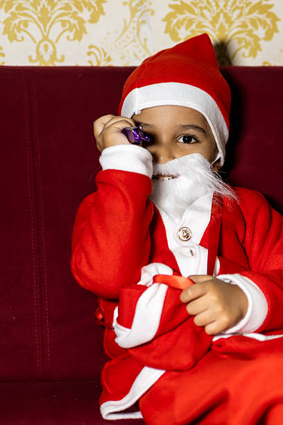 istock christmas celebration with child dressed as santa claus 2252340463