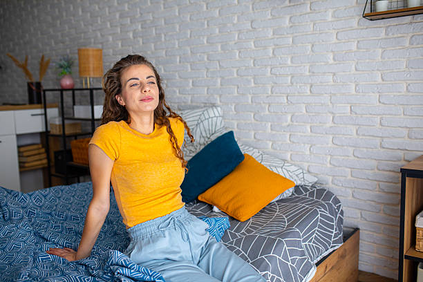 istock Rested woman sitting on bed in the morning light 2252340577