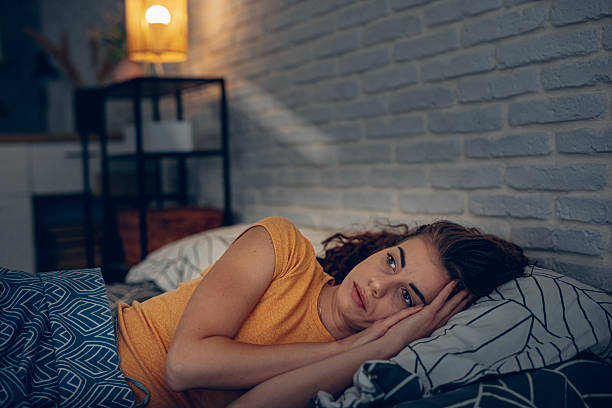 istock Exhausted woman resting in bed, unable to fall asleep 2252342122