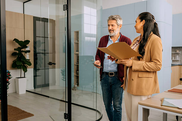 istock Colleagues walking and reviewing document at the office 2252343405